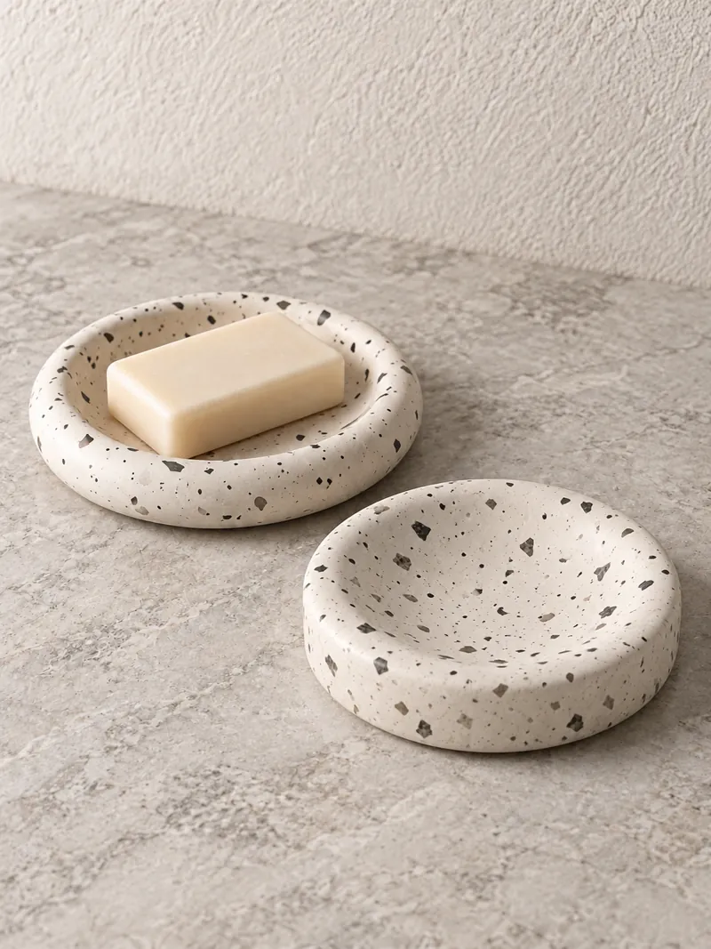 A bar resting on a speckled stone soap dish.